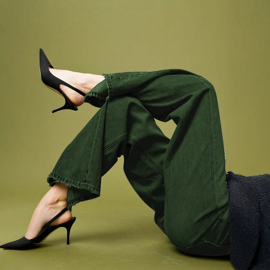 Stylish woman in olive green dyed denim pants created with Kadam Pakka Rang bold earthy fashion color.