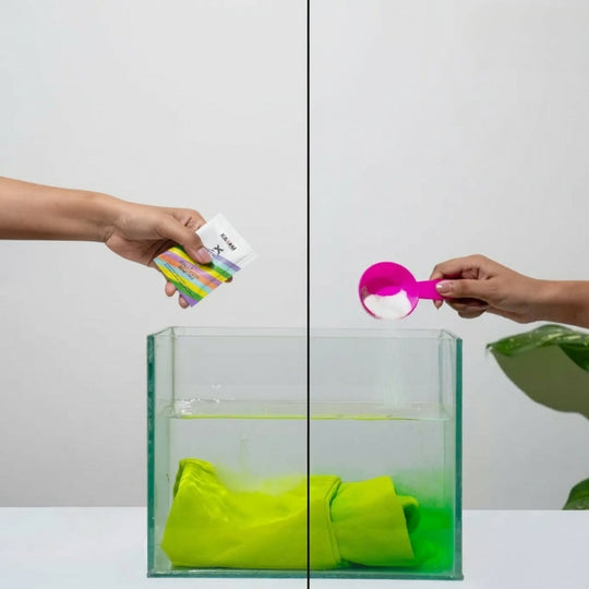 Comparison of two hands pouring DyFix and salt into separate tanks with dyed fabric, demonstrating the superior color-locking performance of DyFix.