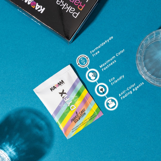 Kadam Colors DyFix fabric care solution on a blue surface, with icons highlighting eco-friendly and color-locking benefits.