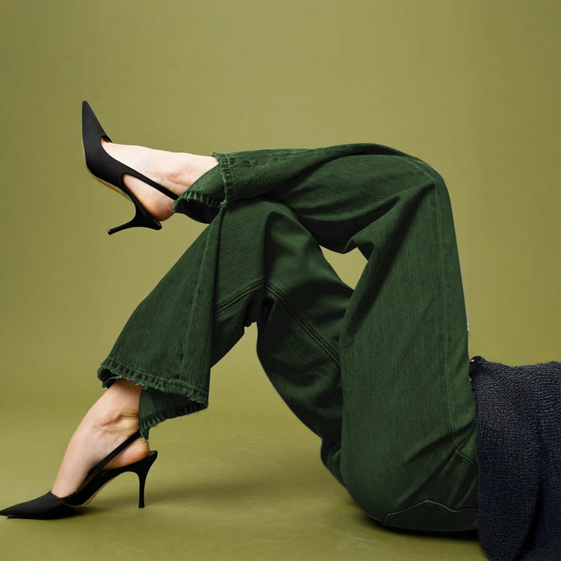 Stylish woman in olive green dyed denim pants created with Kadam Pakka Rang bold earthy fashion color.