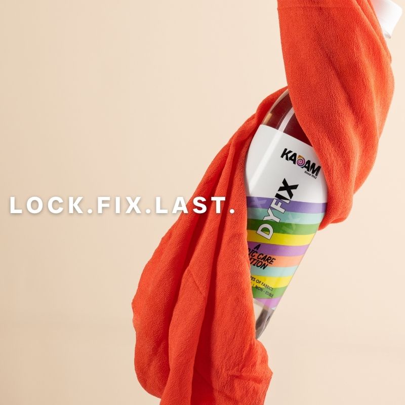 Kadam Colors DyFix liquid bottle wrapped in orange cloth with the tagline “LOCK. FIX. LAST.” on beige background.
